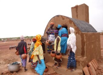 Women potters loading a traditional kiln in the Sahel