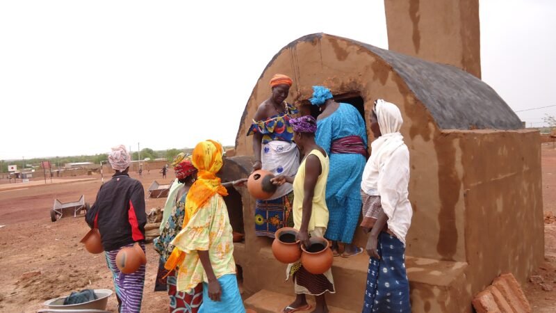 Women potters loading a traditional kiln in the Sahel